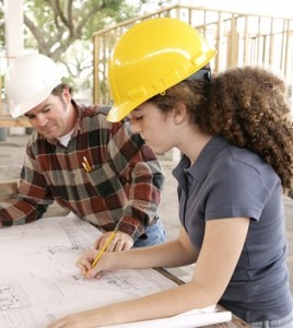 engineering student marking blueprints